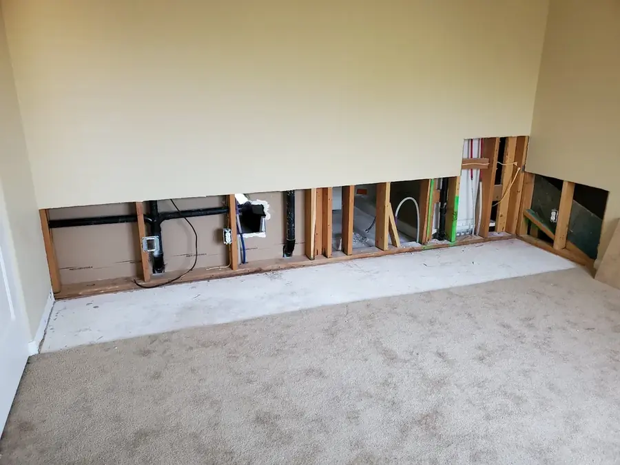 Flooded crawl space under a Spokane home with saturated insulation being removed